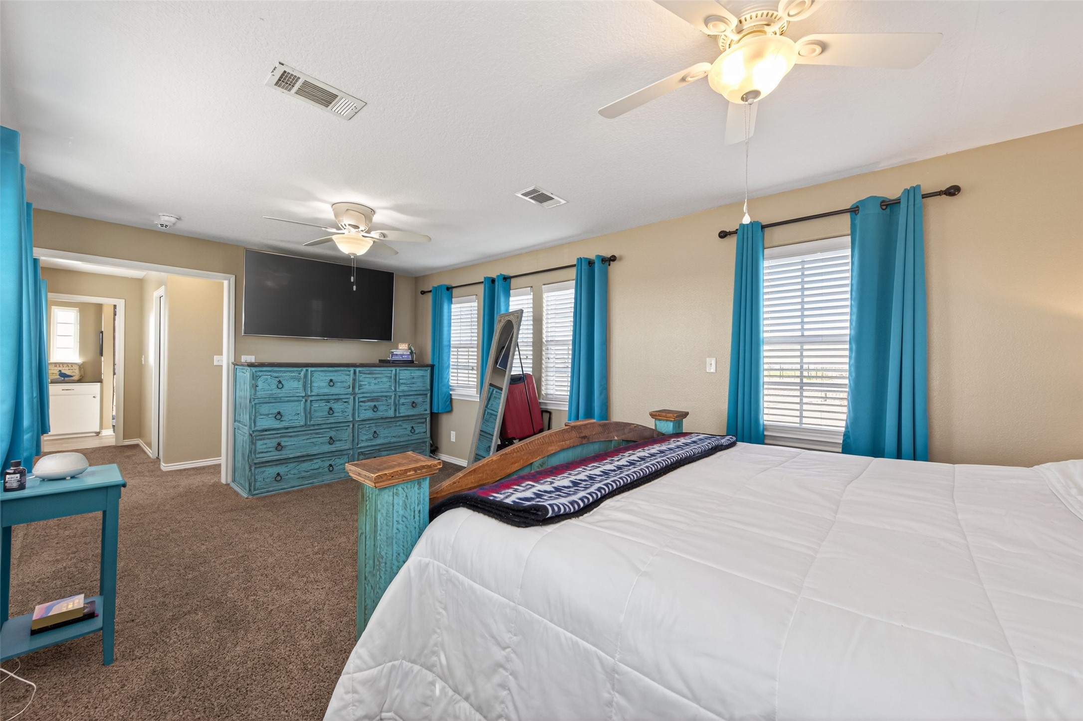 1127 County Road 299 Sargent, TX 77414 - Photo 46 of 46 a spacious bedroom with a bed and a chandelier