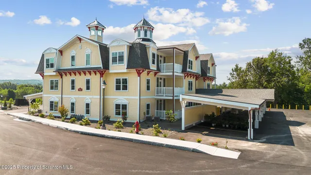 a kitchen with stainless steel appliances granite countertop a sink dishwasher a stove and a refrigerator with wooden floor