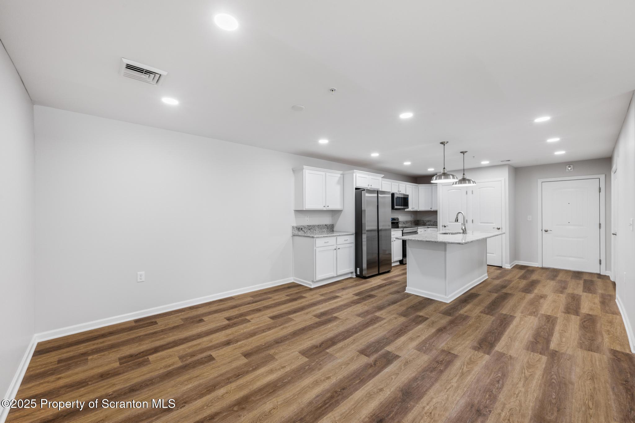 47 Zackery Way Old Forge, PA 18518 - Photo 11 of 26 a open kitchen with white cabinets and white appliances