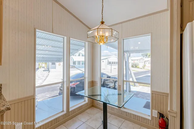 a view of a hallway with wooden floor and glass door