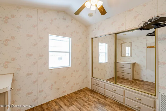 a view of a livingroom with wooden floor and cabinet