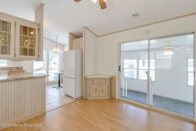 a kitchen with granite countertop a refrigerator and a stove top oven