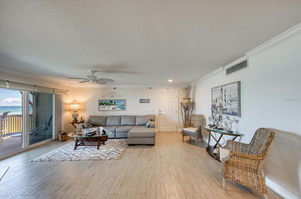 19930 Gulf Boulevard, Unit 5C Indian Shores, FL 33785 - Photo 15 of 55 a living room with furniture and a wooden floor