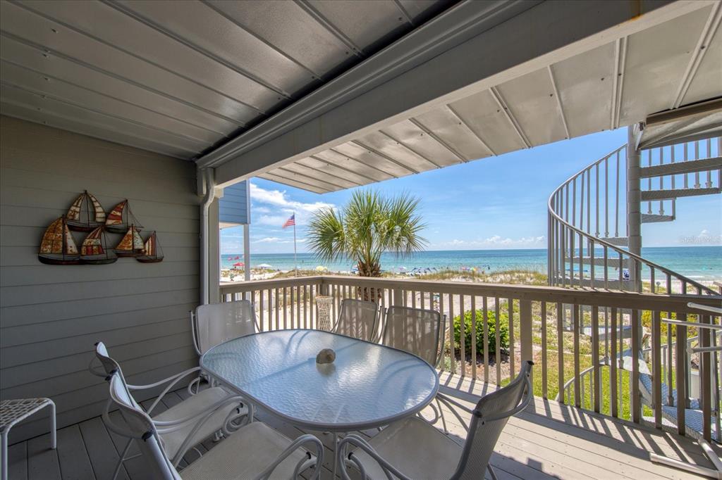 19930 Gulf Boulevard, Unit 5C Indian Shores, FL 33785 - Photo 22 of 55 a view of a chairs and table in the balcony