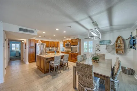 a kitchen with stainless steel appliances granite countertop a refrigerator and a sink