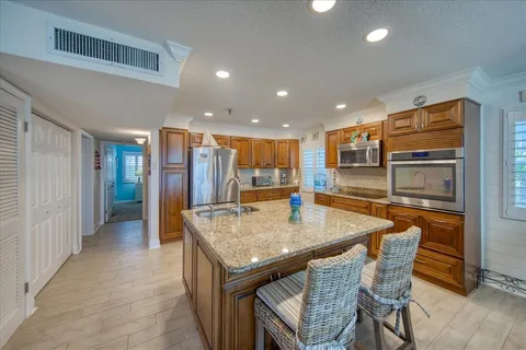 a kitchen with stainless steel appliances a refrigerator and microwave