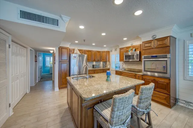 a kitchen with stainless steel appliances a refrigerator and microwave