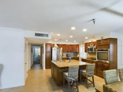 a kitchen with a refrigerator and cabinets