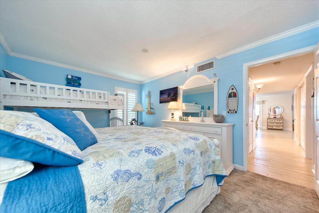 19930 Gulf Boulevard, Unit 5C Indian Shores, FL 33785 - Photo 32 of 55 a bed room with a bed and a television