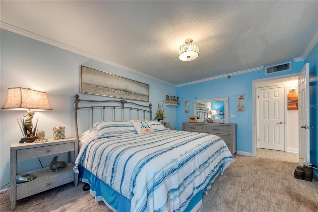 19930 Gulf Boulevard, Unit 5C Indian Shores, FL 33785 - Photo 36 of 55 a bedroom with a bed and a lamp