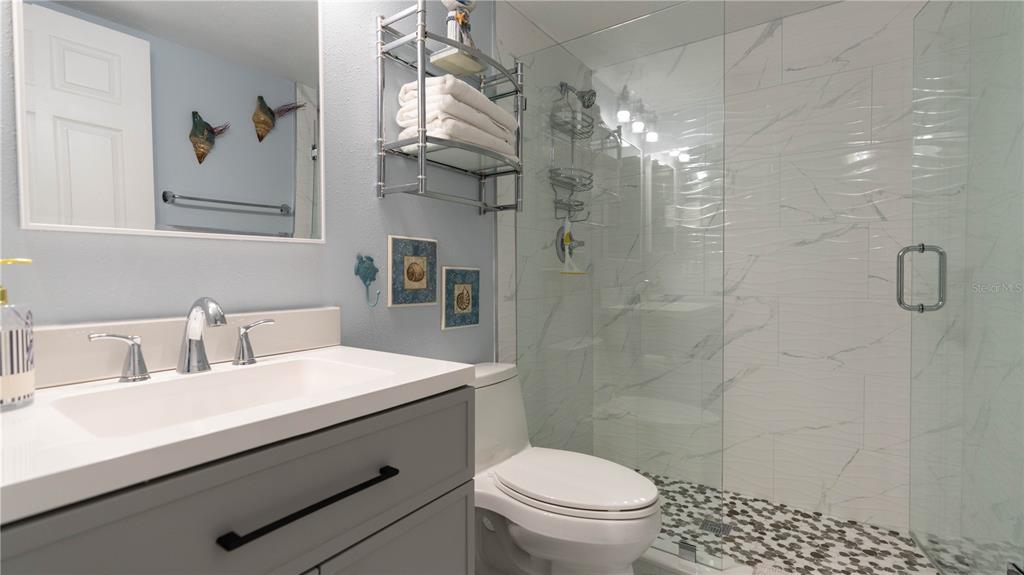 19930 Gulf Boulevard, Unit 5C Indian Shores, FL 33785 - Photo 38 of 55 a bathroom with a sink a toilet and shower