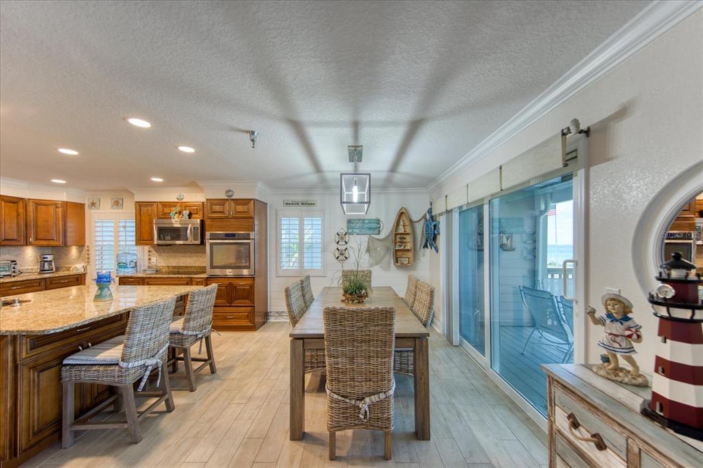 19930 Gulf Boulevard, Unit 5C Indian Shores, FL 33785 - Photo 6 of 55 a view of a dining room with furniture a chandelier and wooden floor