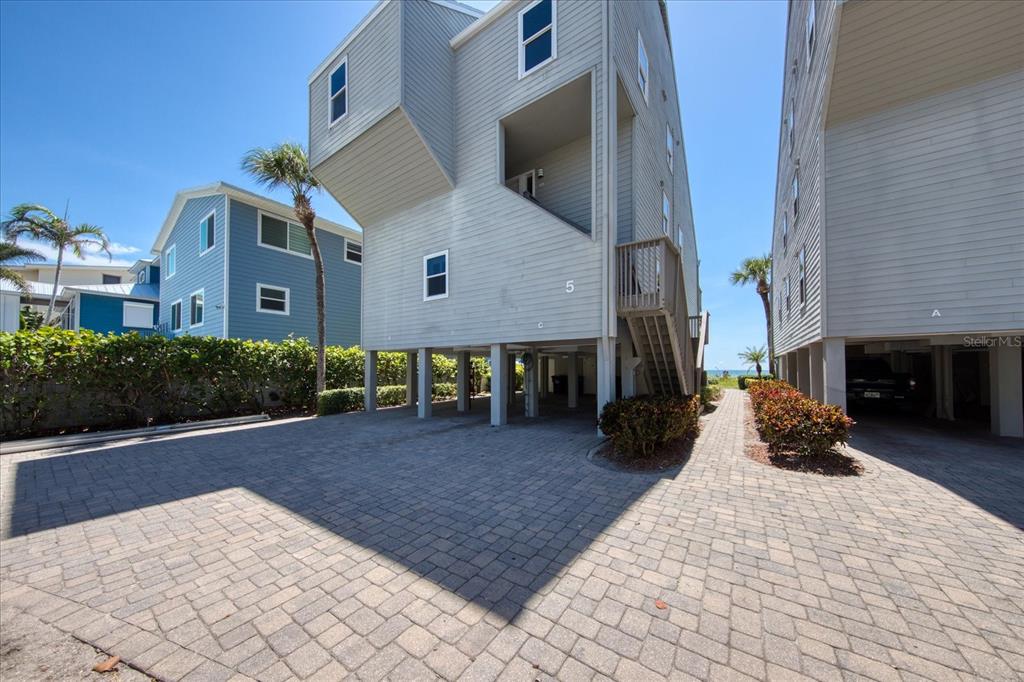 19930 Gulf Boulevard, Unit 5C Indian Shores, FL 33785 - Photo 9 of 55 a front view of a house with yard and potted plants