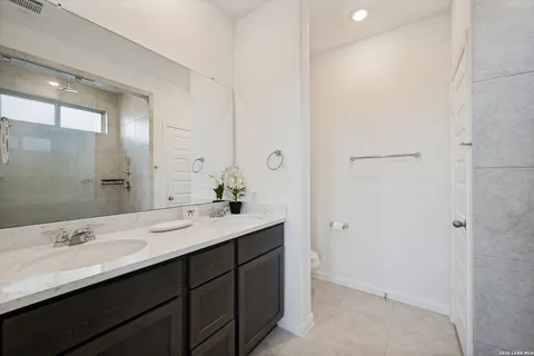 a bathroom with a double vanity sink and mirror