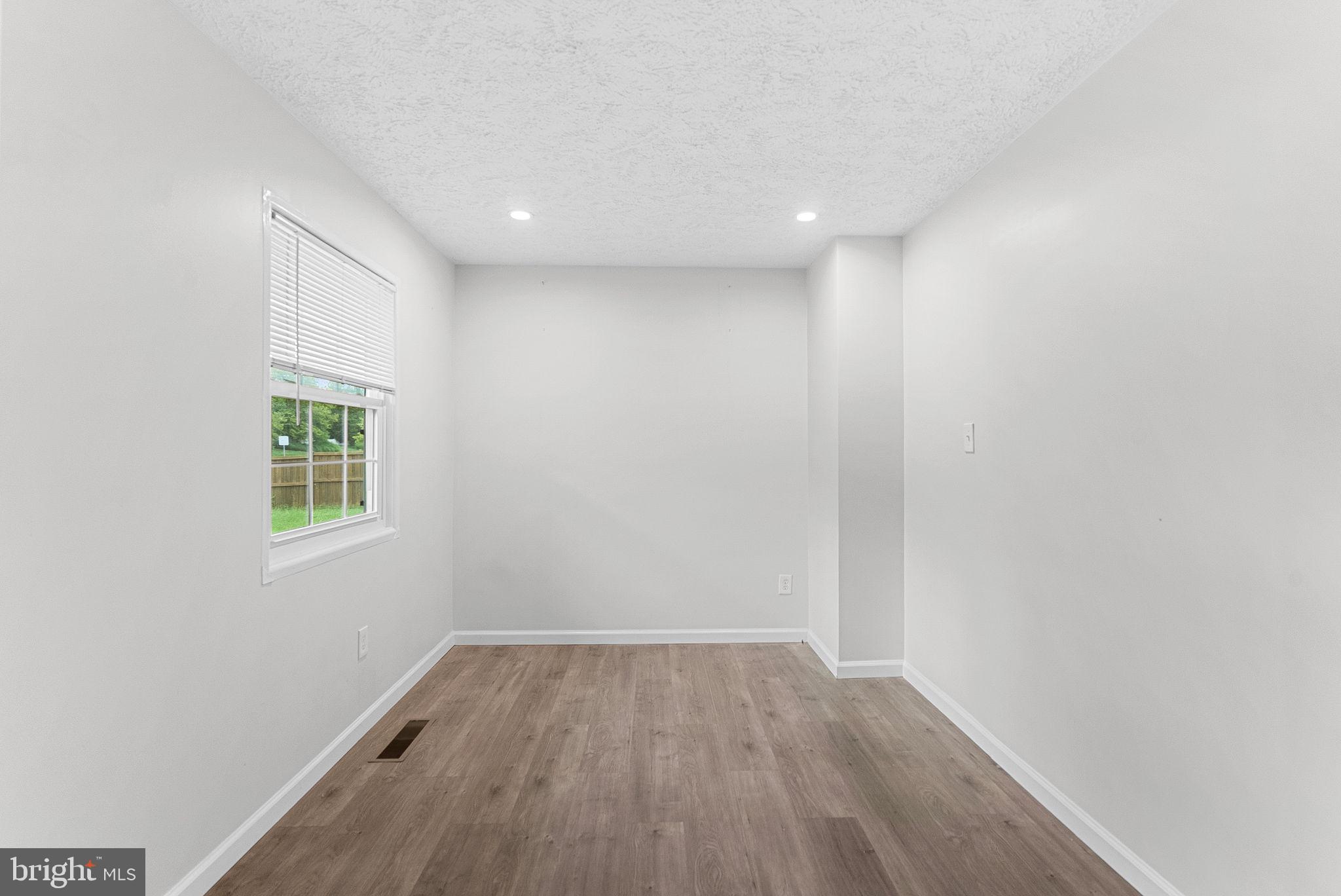 21506 Shellhorn Road Ashburn, VA 20147 - Photo 12 of 42 an empty room with wooden floor and windows