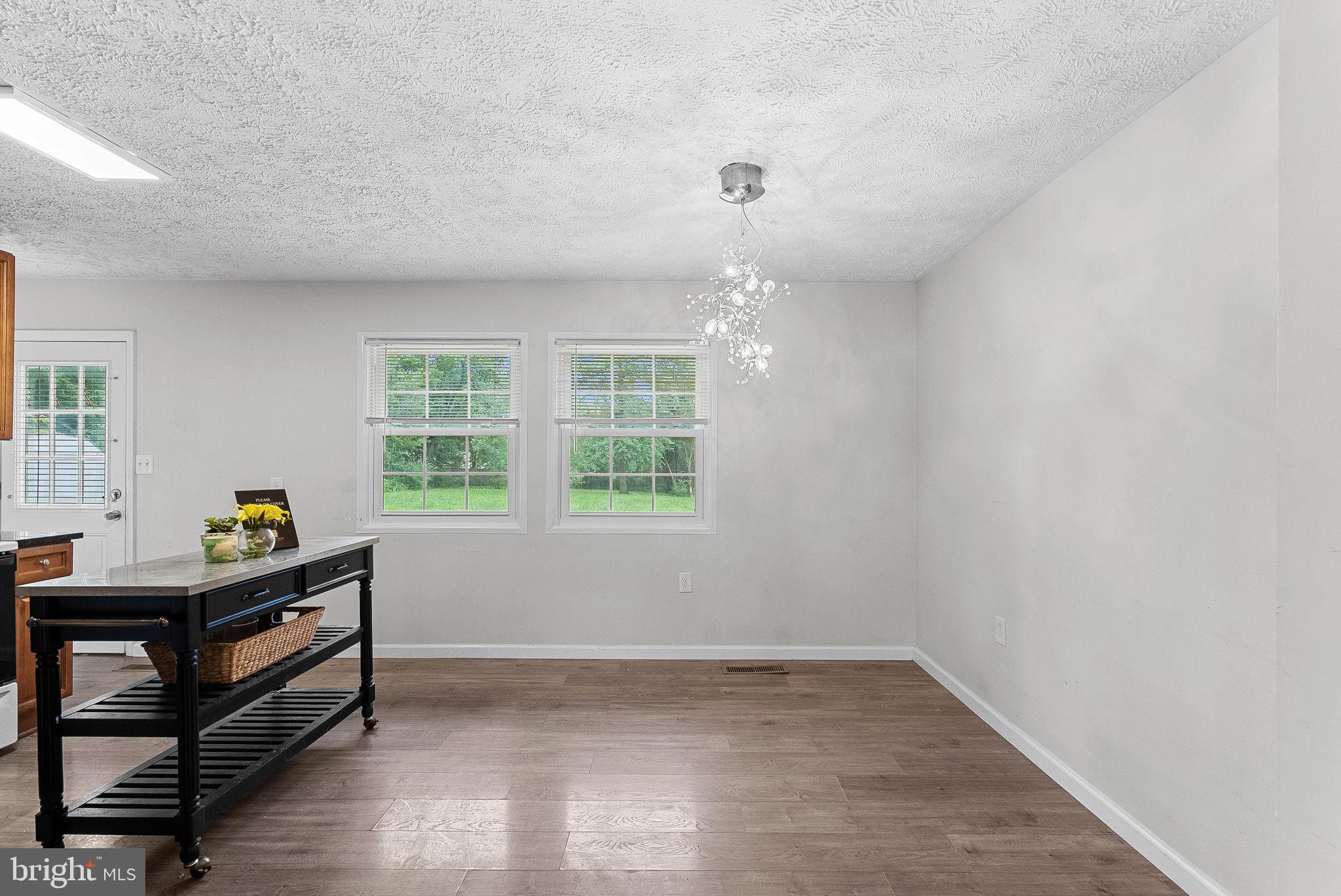 21506 Shellhorn Road Ashburn, VA 20147 - Photo 15 of 42 a room with wooden floor and windows