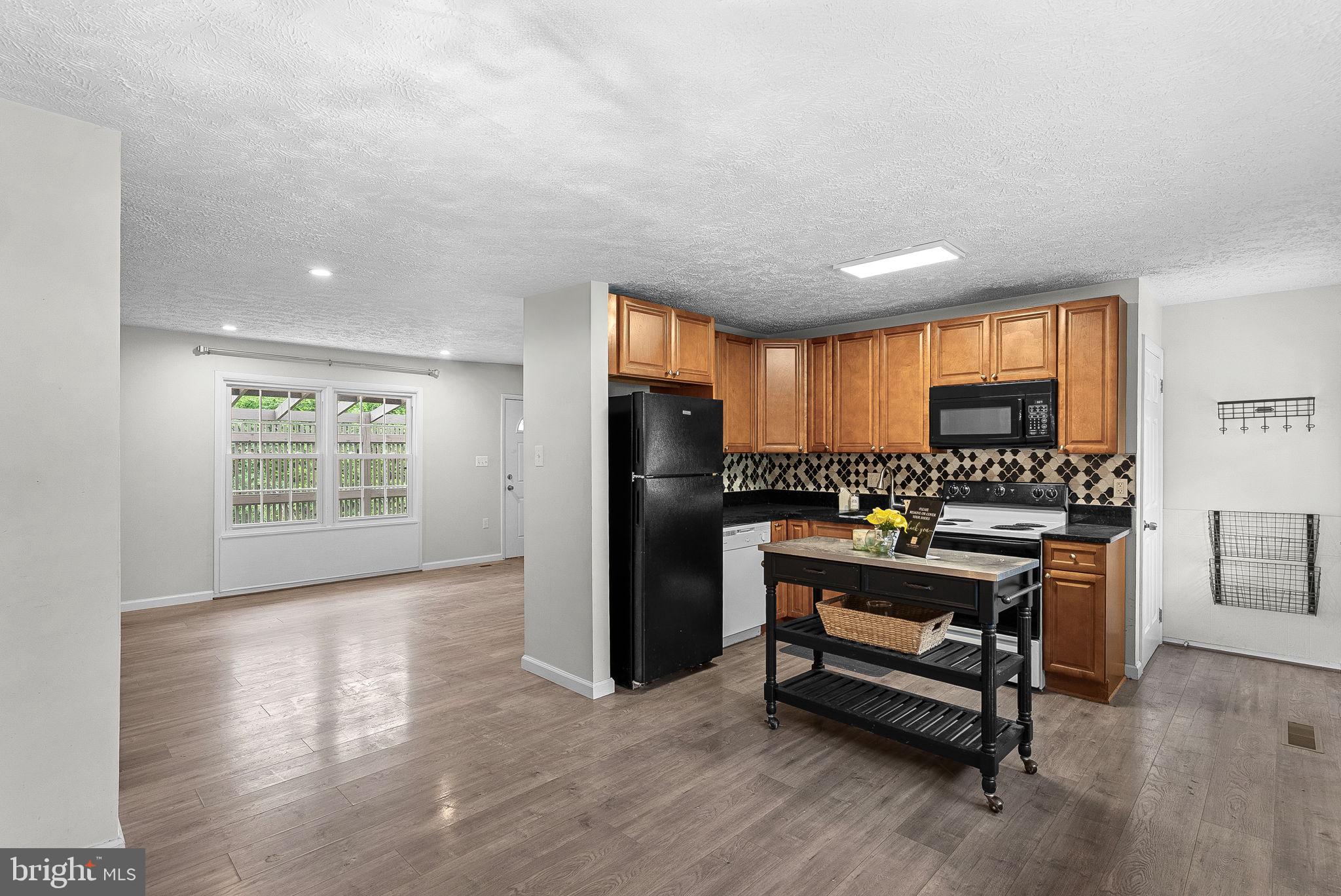 21506 Shellhorn Road Ashburn, VA 20147 - Photo 17 of 42 a kitchen with stainless steel appliances granite countertop a refrigerator a stove and a wooden floors