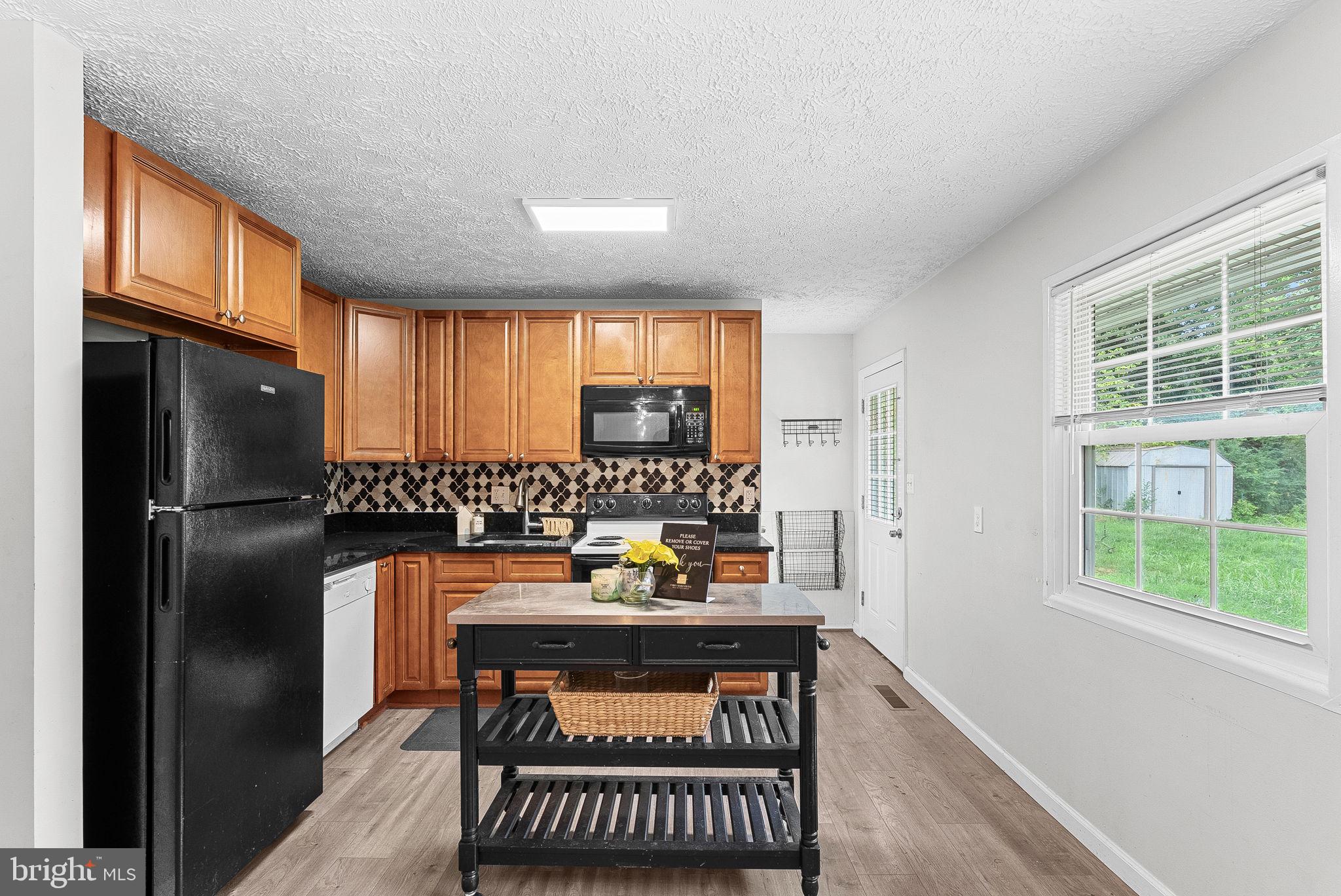 21506 Shellhorn Road Ashburn, VA 20147 - Photo 18 of 42 a kitchen with stainless steel appliances a refrigerator and a window