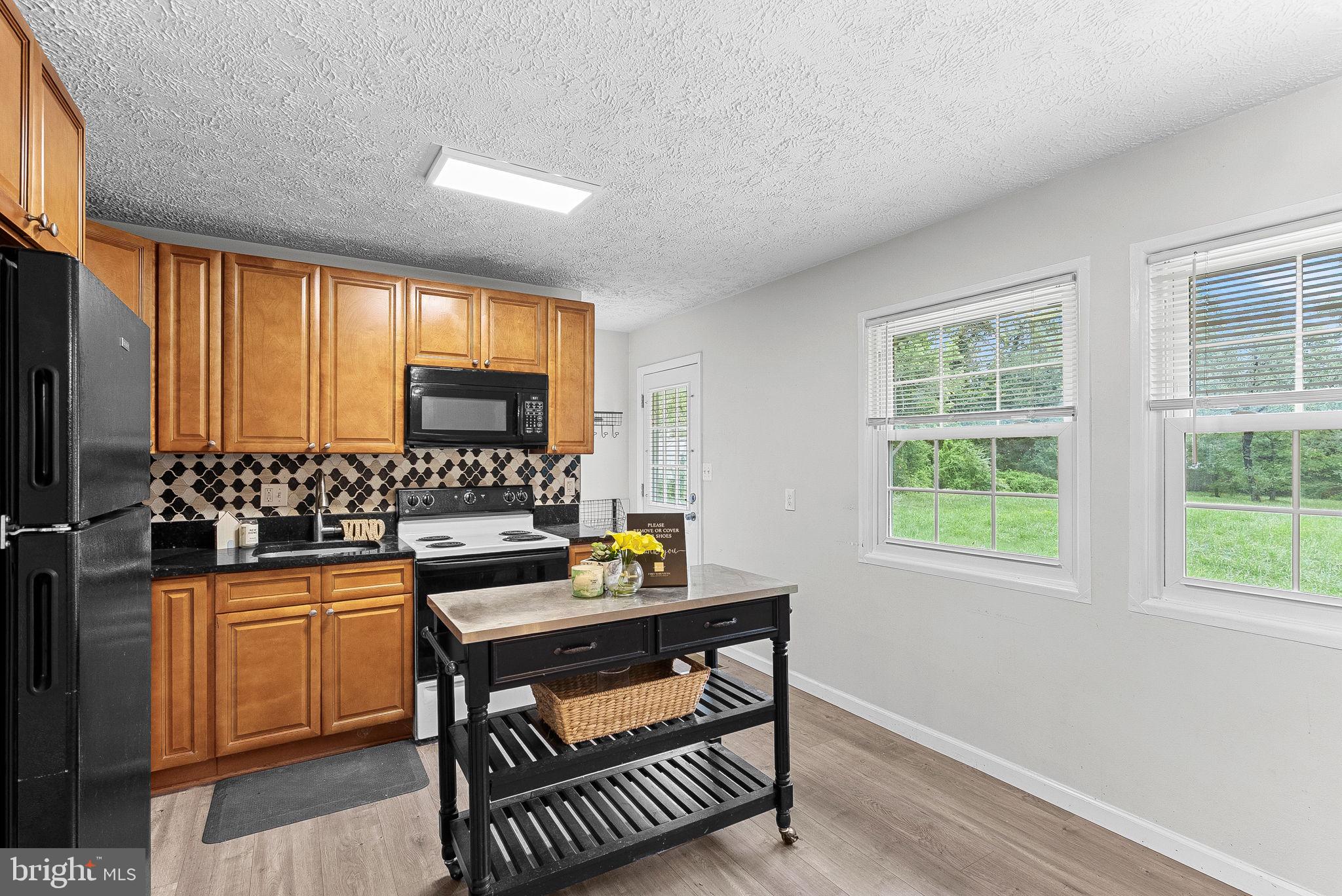 21506 Shellhorn Road Ashburn, VA 20147 - Photo 19 of 42 a kitchen with a sink stove and cabinets