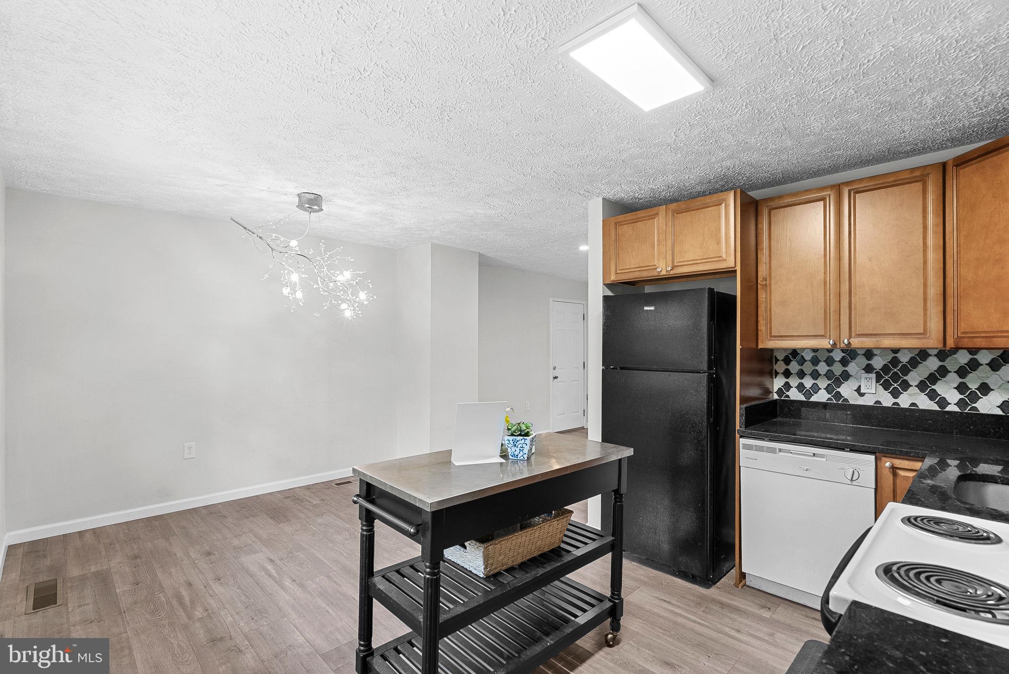 21506 Shellhorn Road Ashburn, VA 20147 - Photo 21 of 42 a living room with stainless steel appliances furniture a rug and a window
