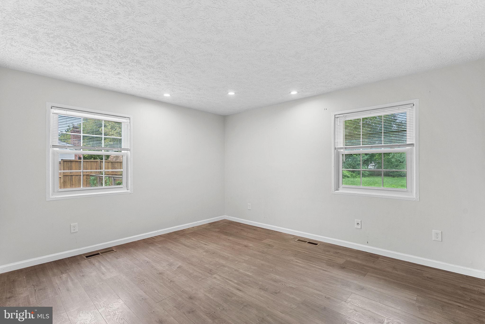 21506 Shellhorn Road Ashburn, VA 20147 - Photo 22 of 42 an empty room with wooden floor and windows