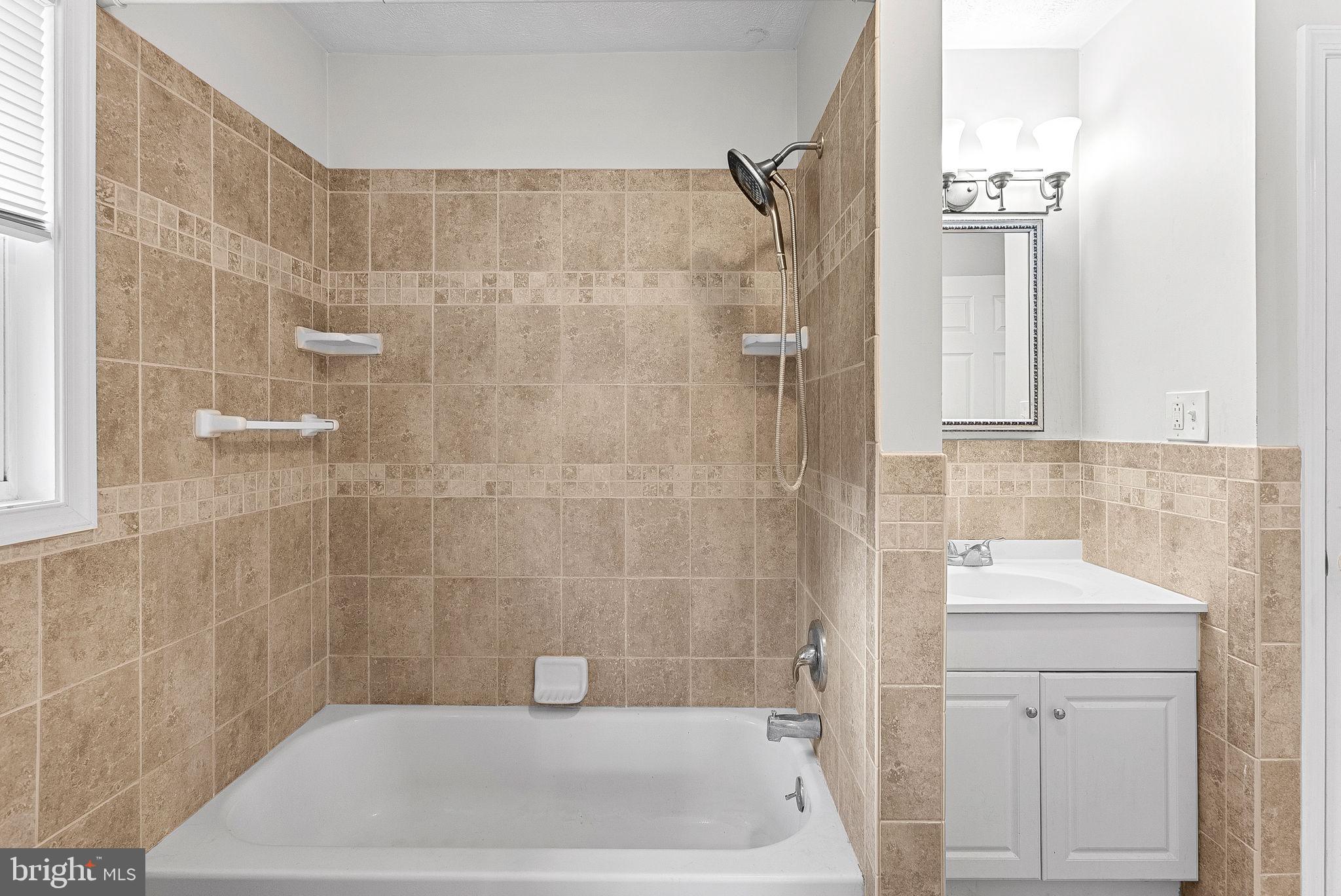 21506 Shellhorn Road Ashburn, VA 20147 - Photo 25 of 42 a bathroom with a sink a toilet a shower and bathtub