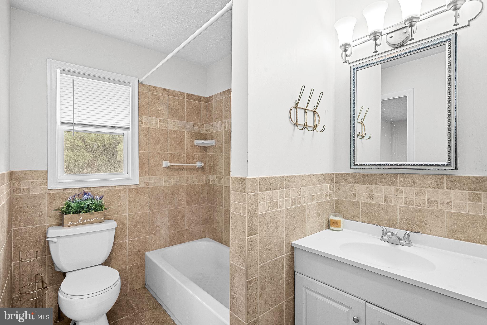 21506 Shellhorn Road Ashburn, VA 20147 - Photo 26 of 42 a bathroom with a sink a toilet and shower