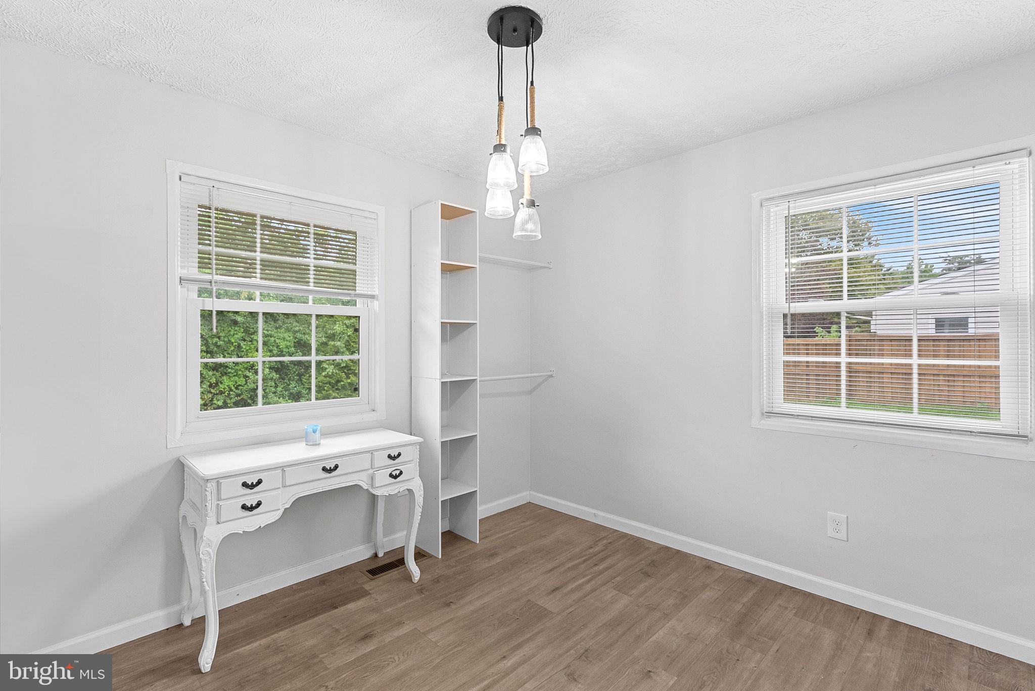 21506 Shellhorn Road Ashburn, VA 20147 - Photo 27 of 42 an empty room with a window and wooden floor