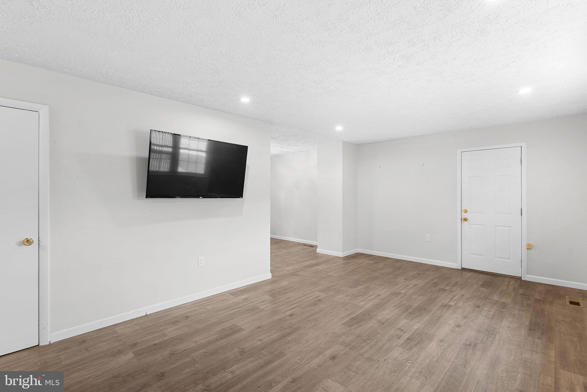 21506 Shellhorn Road Ashburn, VA 20147 - Photo 7 of 42 a view of an empty room with wooden floor and windows