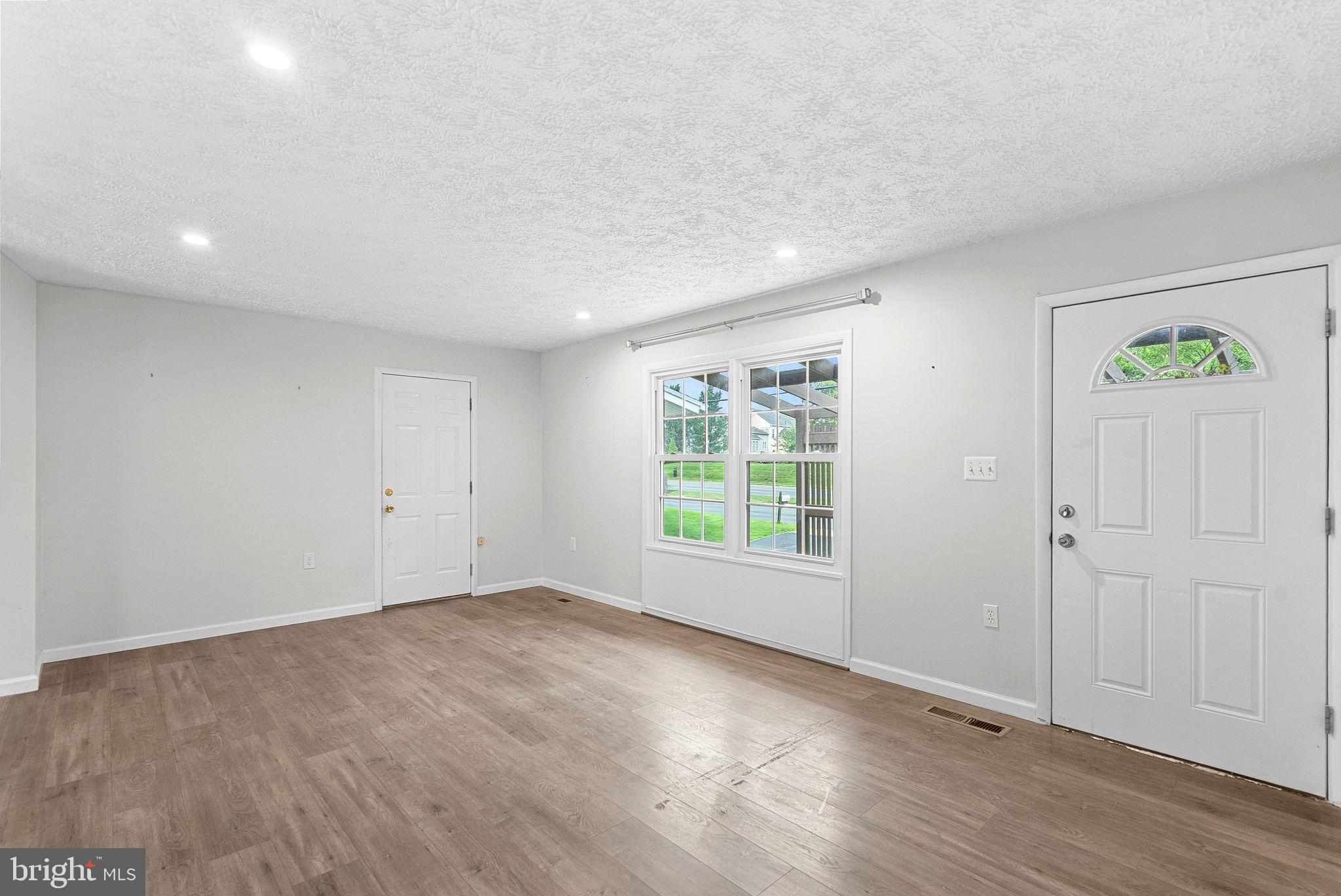 21506 Shellhorn Road Ashburn, VA 20147 - Photo 9 of 42 wooden floor in an empty room with a window
