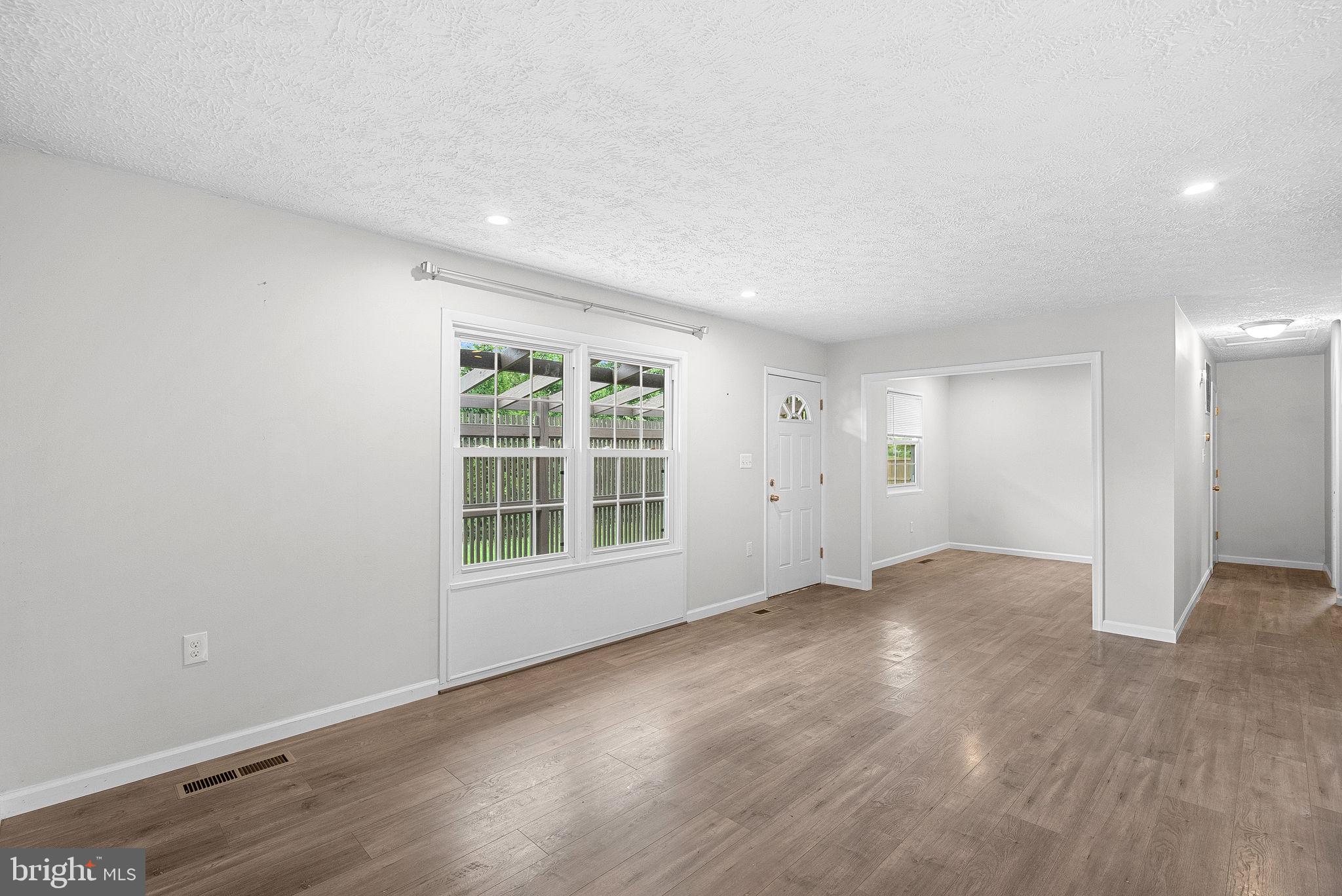 21506 Shellhorn Road Ashburn, VA 20147 - Photo 10 of 42 an empty room with wooden floor and windows