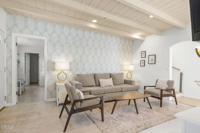 a kitchen with stainless steel appliances granite countertop a stove top oven a sink dishwasher a dining table and chairs with wooden floor