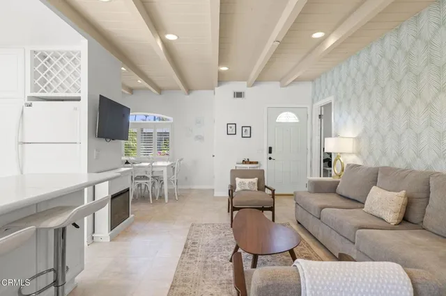 a kitchen with stainless steel appliances granite countertop a sink a stove a microwave and wooden cabinets