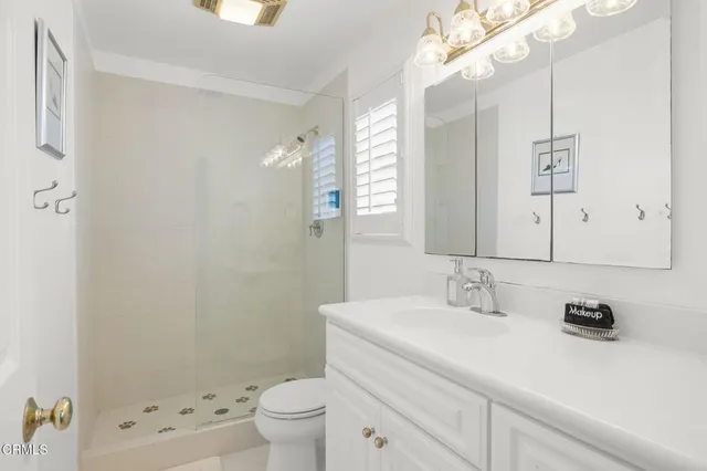 a spacious bedroom with a bed and a chandelier