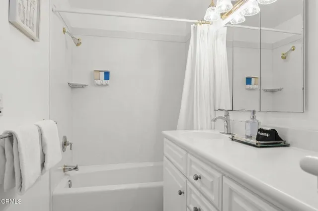 a bedroom with furniture and a wooden floor