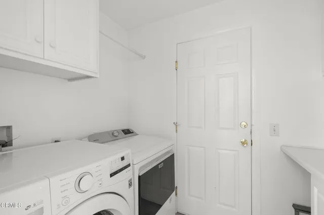 a view of living room filled with furniture and chandelier