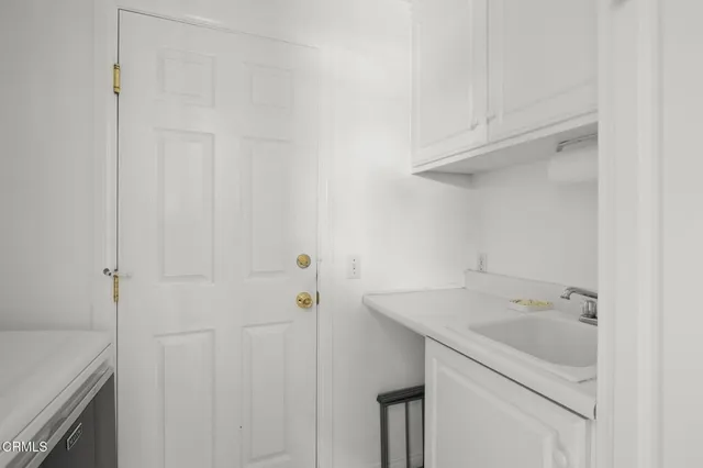 a bedroom with a bed a table and chair