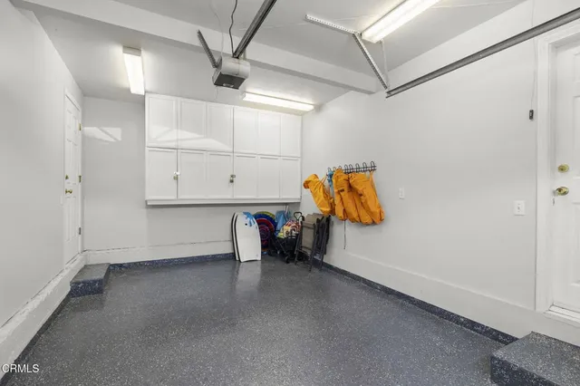a spacious bedroom with a bed a table and potted plant on the table
