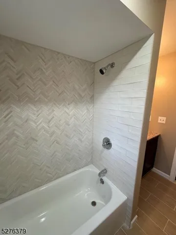 a bathroom with a sink mirror and shower