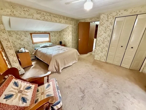 a bed room with a bed and a chair