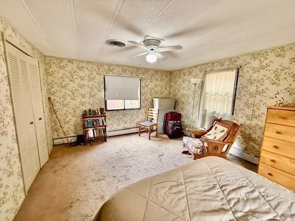 a bed room with a bed and a chair