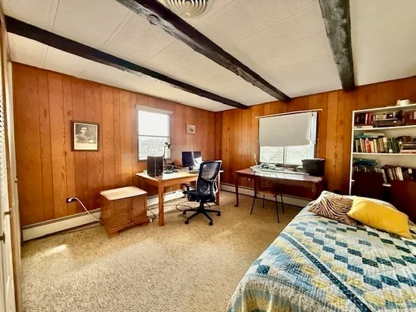 a living room with furniture a rug and a window