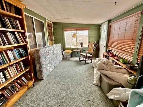 a living room with furniture and a book shelf
