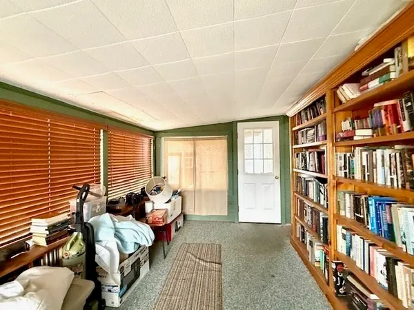 a living room with furniture next to a book shelf