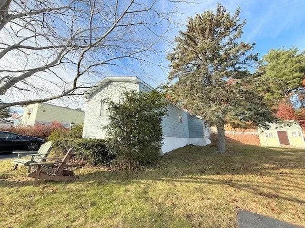 a view of a house with a yard covered in snow