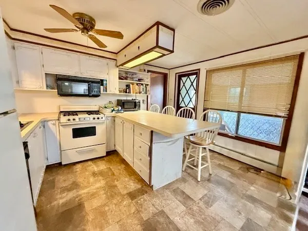a view of a kitchen with a sink and a stove top oven