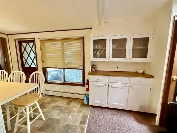 a living room with stainless steel appliances furniture and a window