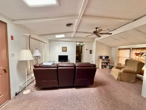 a living room with furniture a couch and a flat screen tv