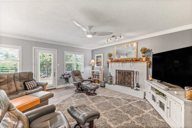 a living room with furniture a flat screen tv and a fireplace