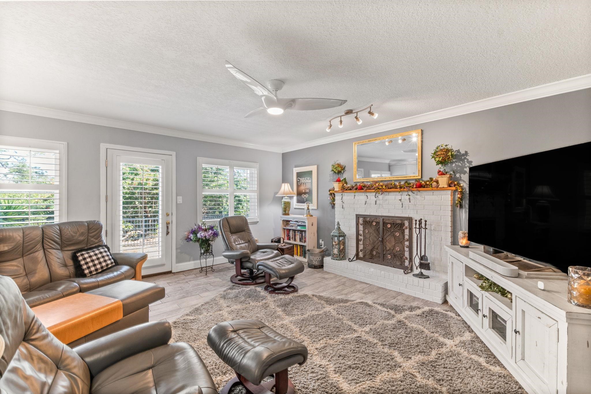 5312 Riverview Drive St. Augustine, FL 32080 - Photo 11 of 54 a living room with furniture a flat screen tv and a fireplace